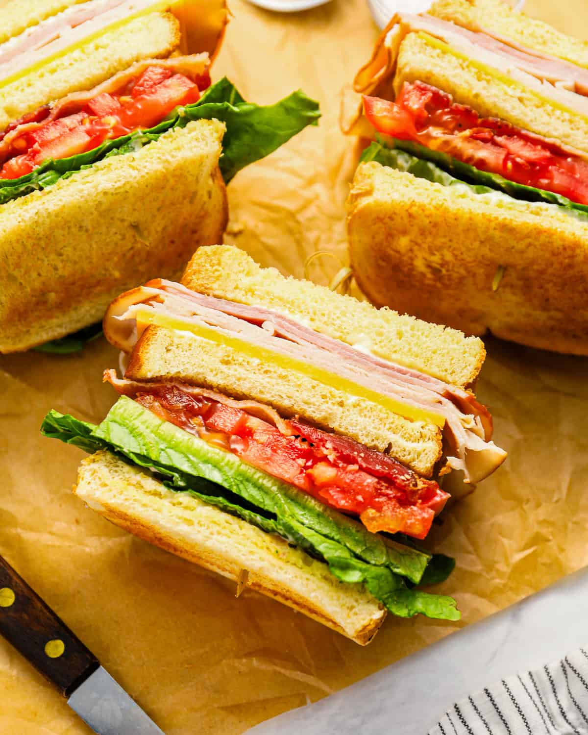 overhead view of club sandwiches turned on their sides to show the layers.