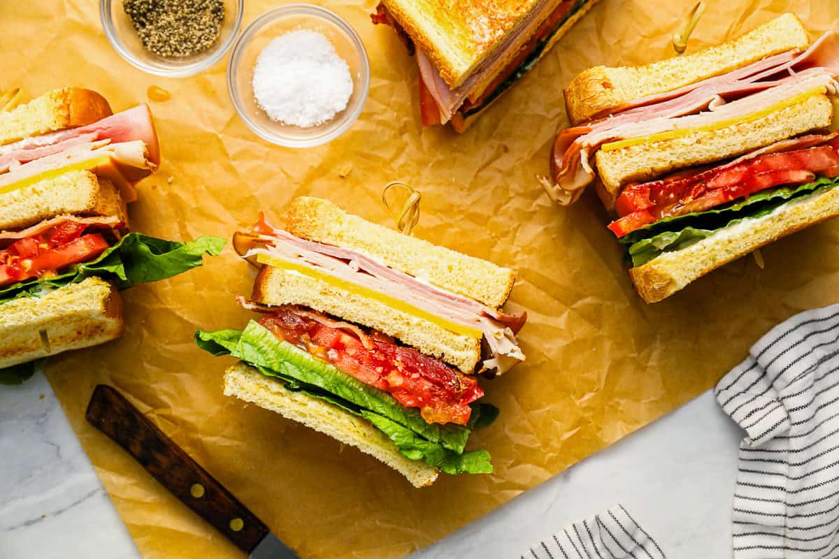 overhead view of club sandwiches turned on their sides to show the layers.