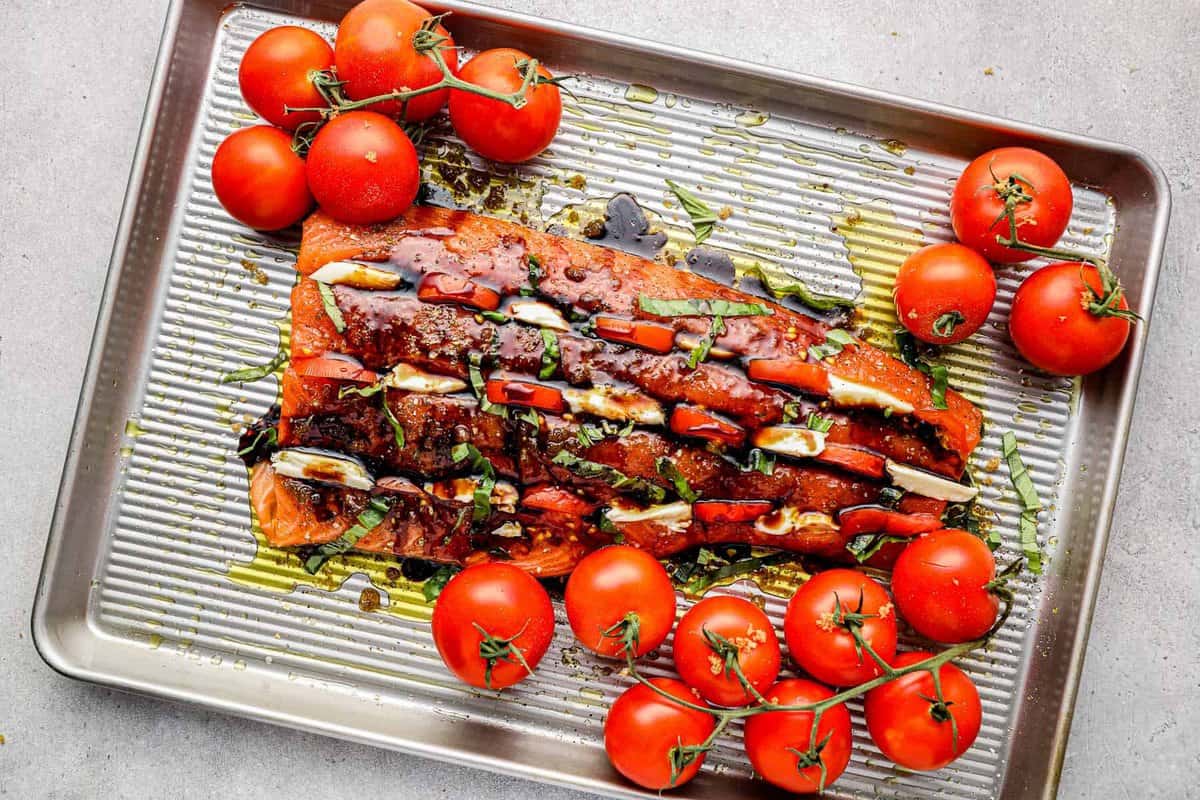 Salmon on a sheet pan, covered in balsamic glaze.