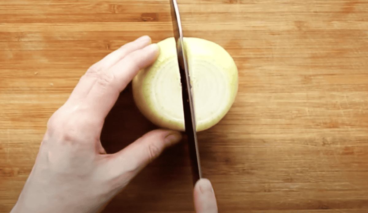 Cutting an onion in half.