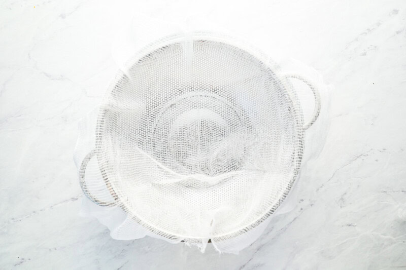 a mesh sieve lined with cheesecloth.