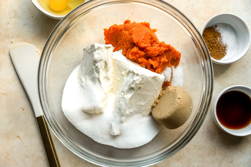 cream cheese, pumpkin, and sugar in a glass bowl.