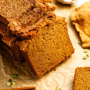 a partially sliced loaf of pumpkin bread.