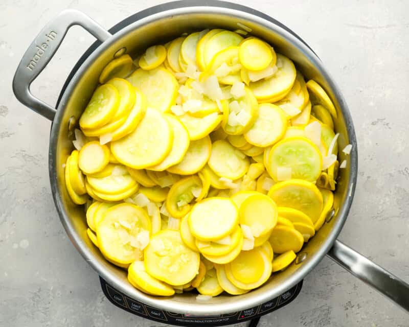 sliced yellow squash in a pan.