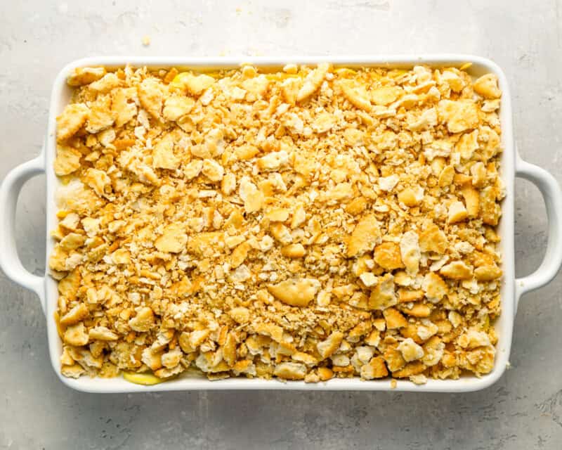 unbaked squash casserole in a baking dish.