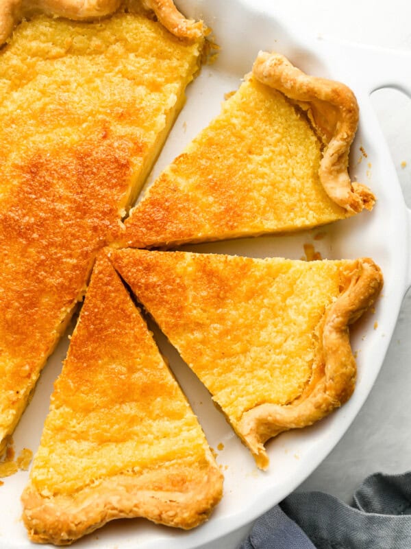 overhead view of a partially sliced buttermilk pie.