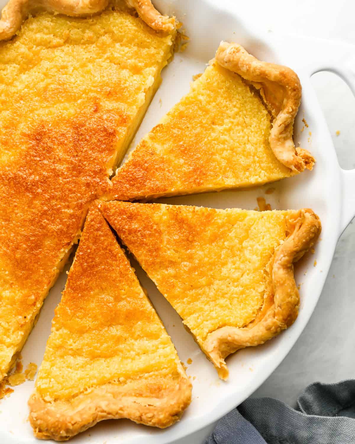 overhead view of a partially sliced buttermilk pie.