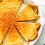 overhead view of a partially sliced buttermilk pie.