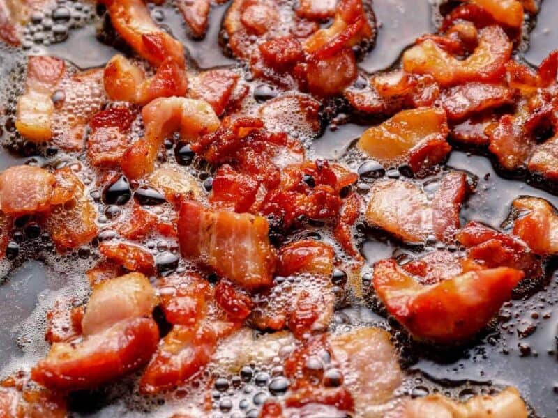 chopped bacon cooking in a skillet