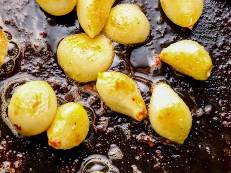 garlic cloves in a skillet