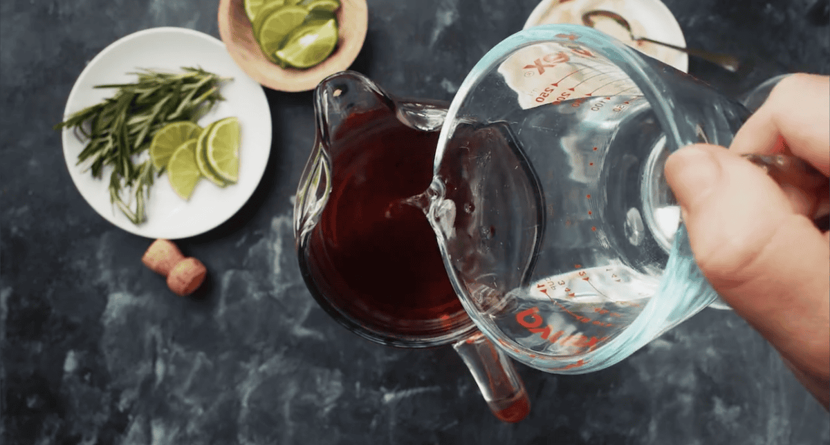 Pouring liquid into a pitcher.