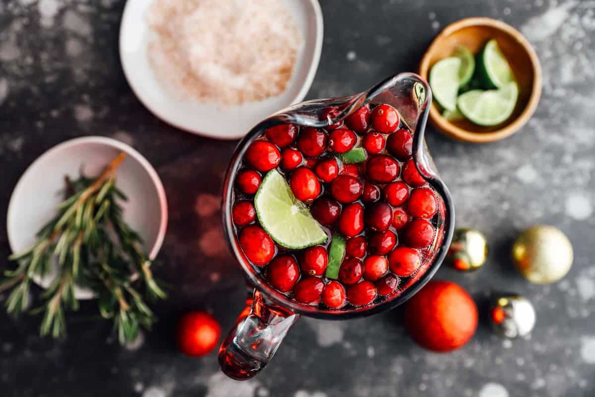 overhead view of jingle juice in a pitcher surrounded by garnishes.