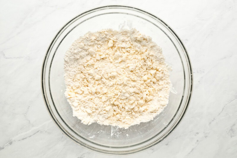 cutting butter into flour in a glass bowl.