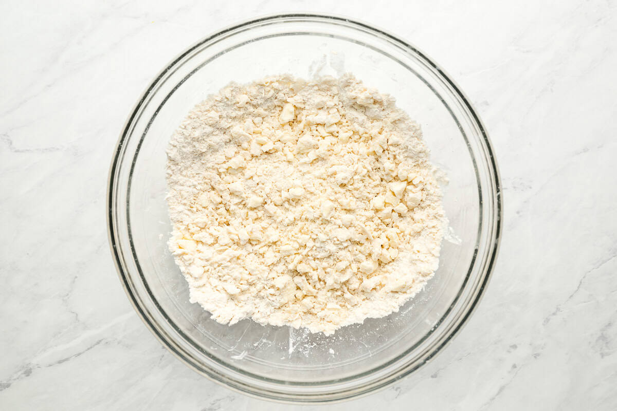 cutting butter into flour in a glass bowl.