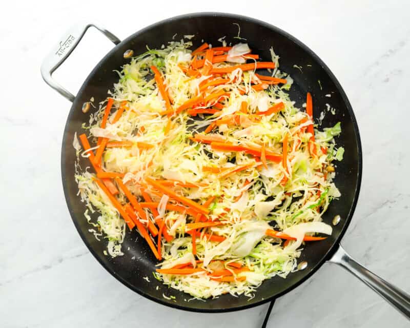 stir fry veggies cooking in black skillet