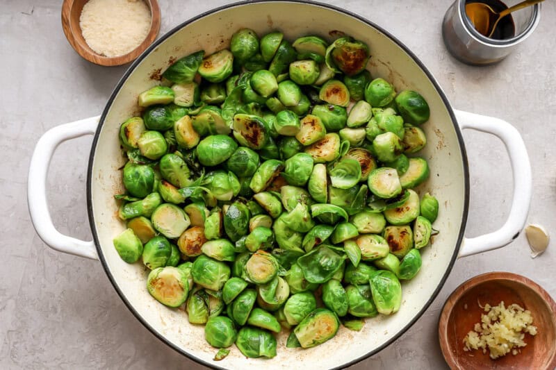 searing brussels sprouts in a pan.