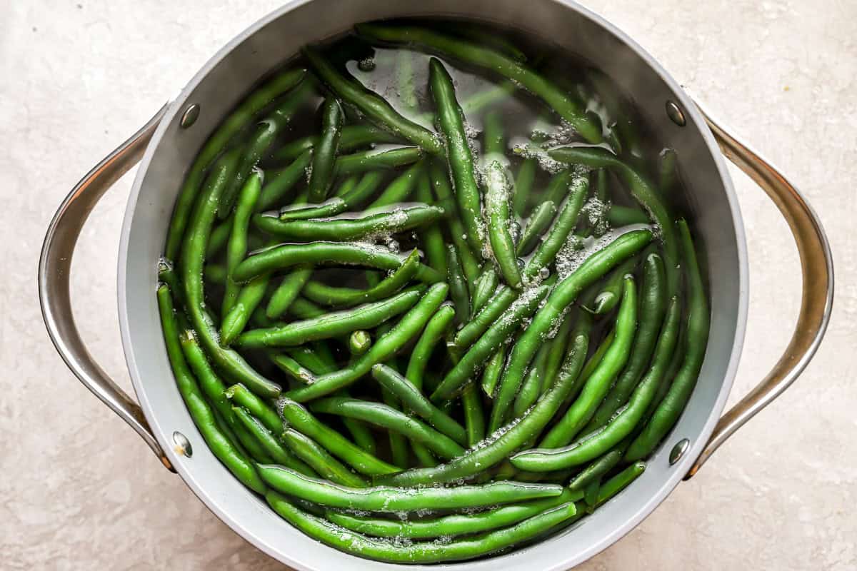 boiling green beans in a pot.