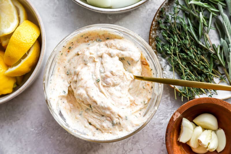 seasoned mayonnaise in a bowl with a spoon.