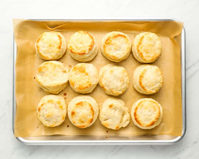 12 baked biscuits on a baking sheet.