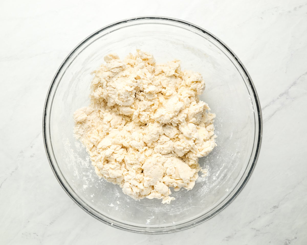 crumbly dough in a glass bowl.