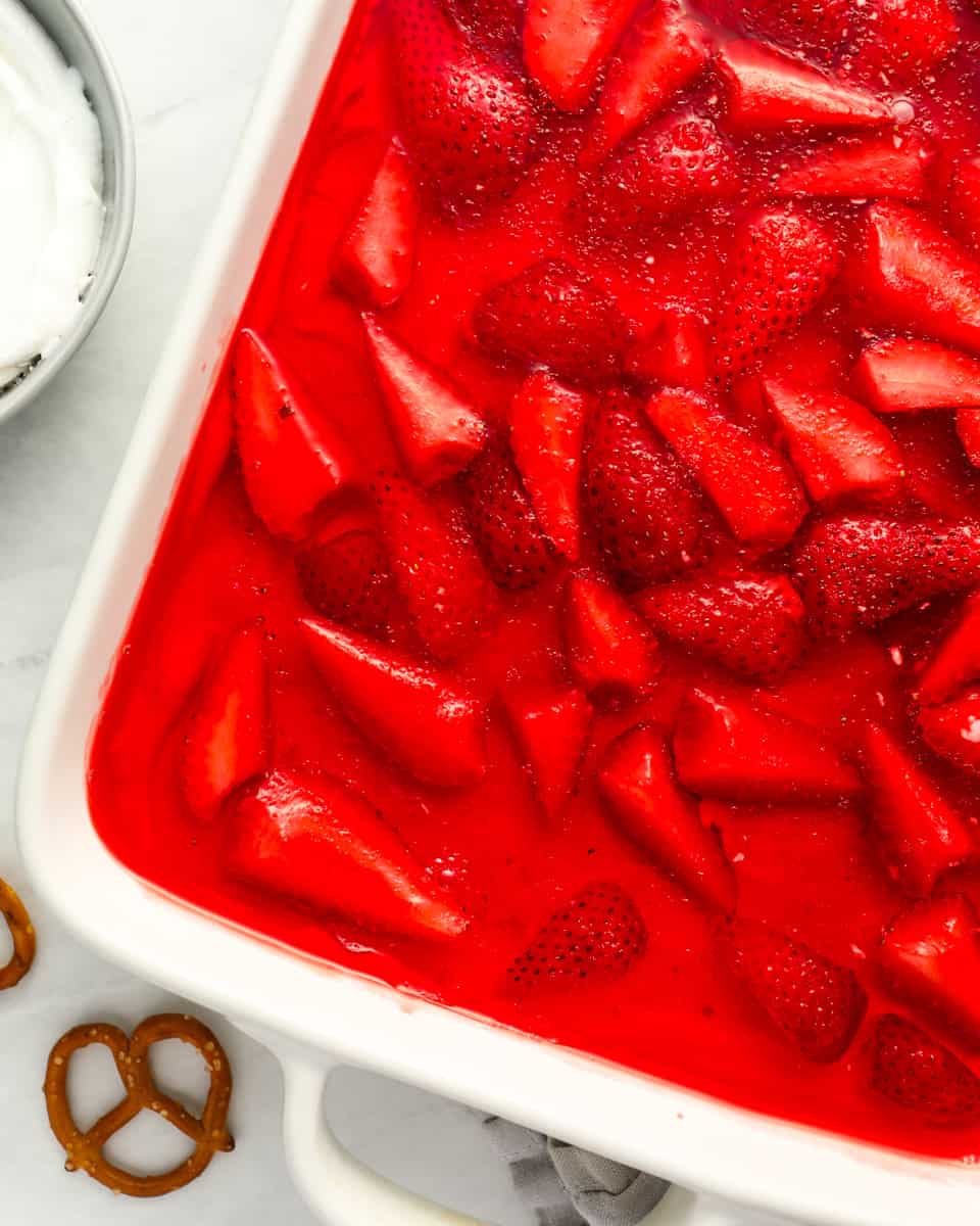 partial overhead view of strawberry pretzel salad in a baking pan.