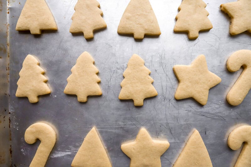 baked christmas cutout cookies on a baking sheet.