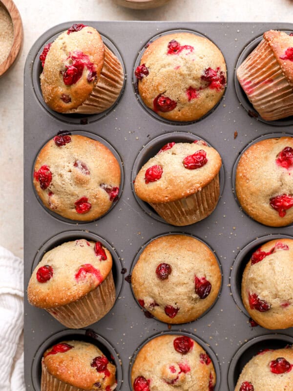 partial overhead view of cranberry muffins in a muffin tin.