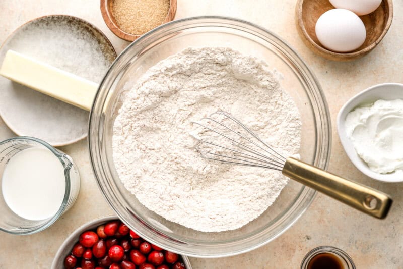 flour in a glass bowl with a whisk.