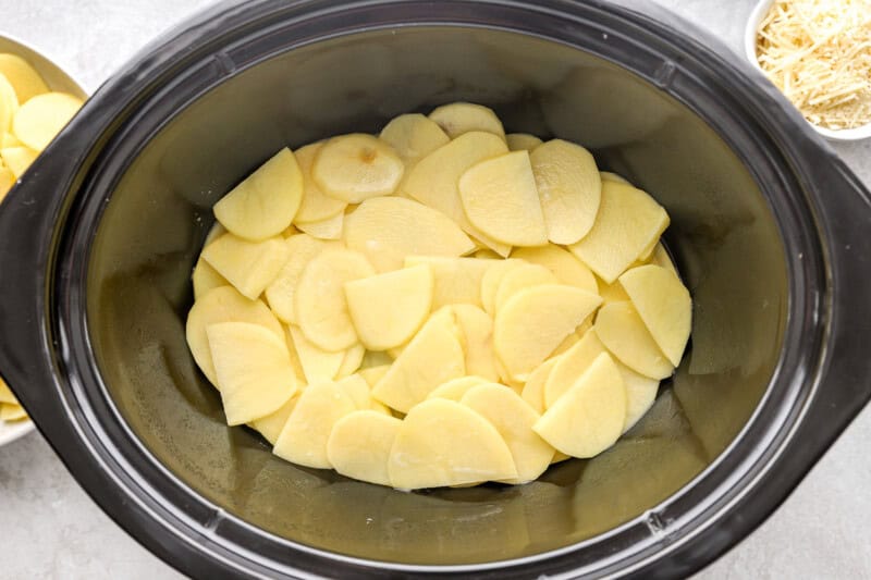 sliced potatoes in a crockpot.