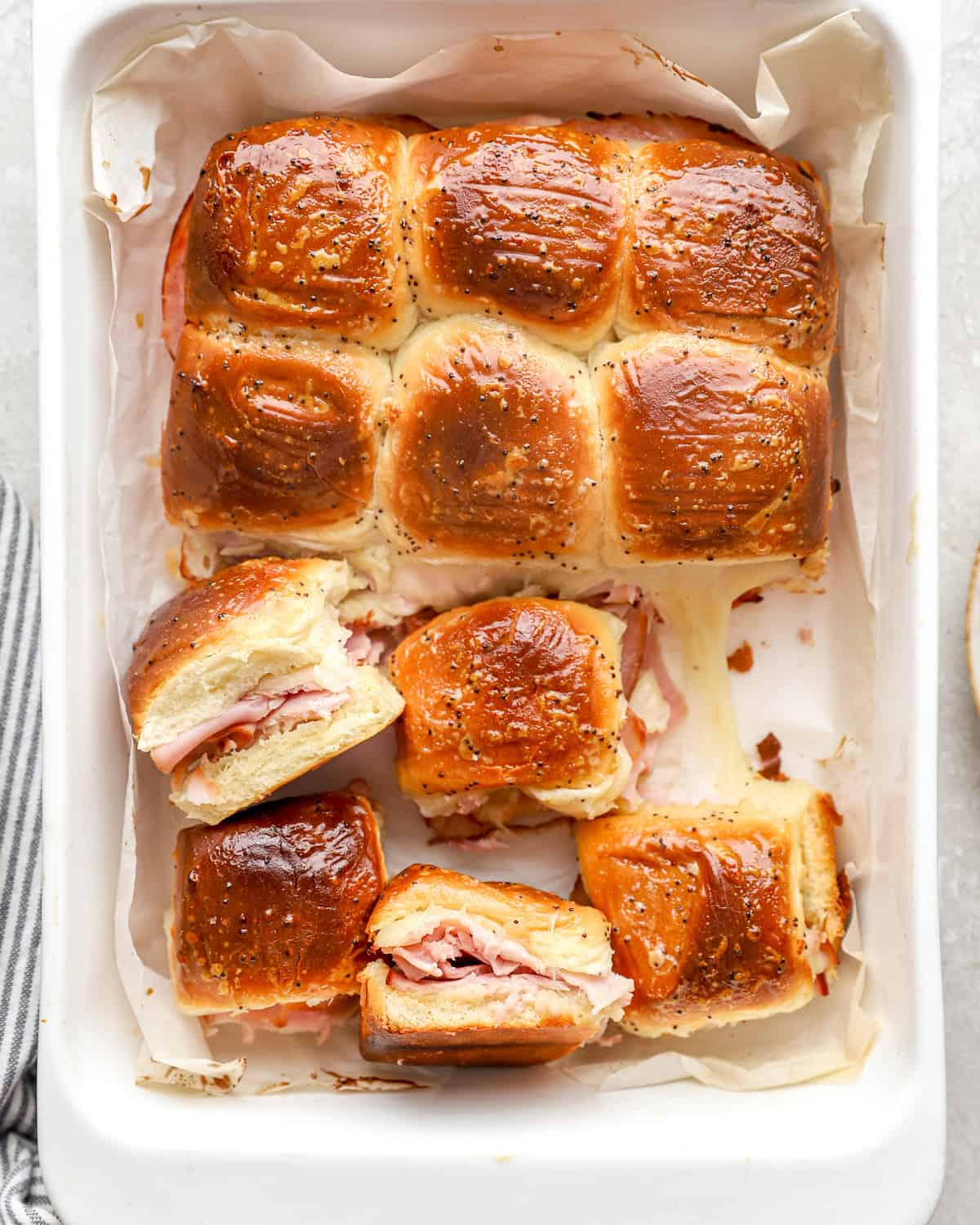 Ham and swiss sliders in a baking dish.