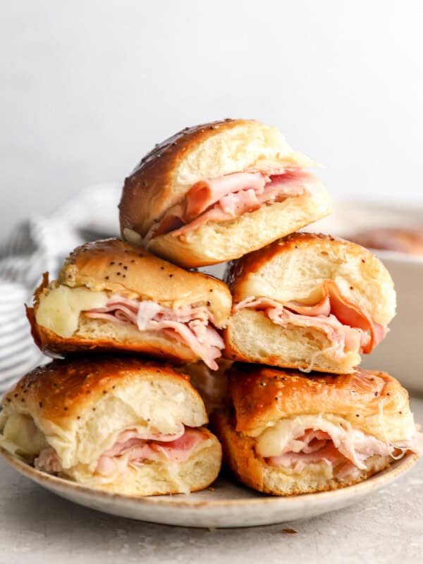 A plate of ham and cheese sliders on Hawaiian rolls.