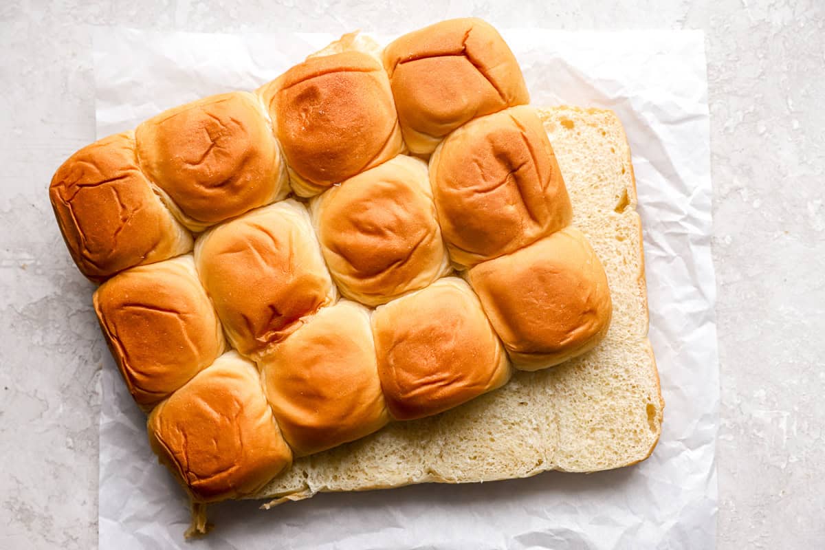 Hawaiian rolls cut in half to separate tops from bottoms.