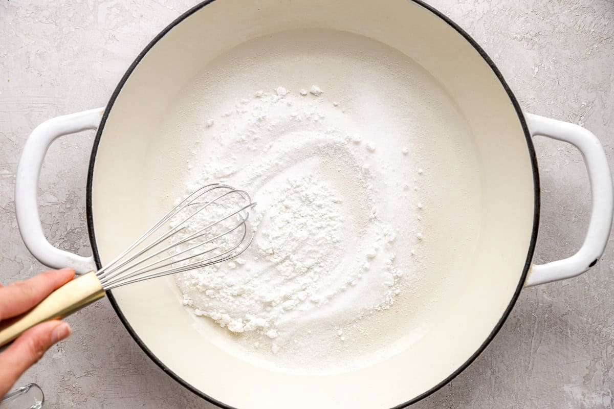 whisking sugar and cornstarch in a pot.