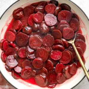 Harvard beets in a pot with a spoon.