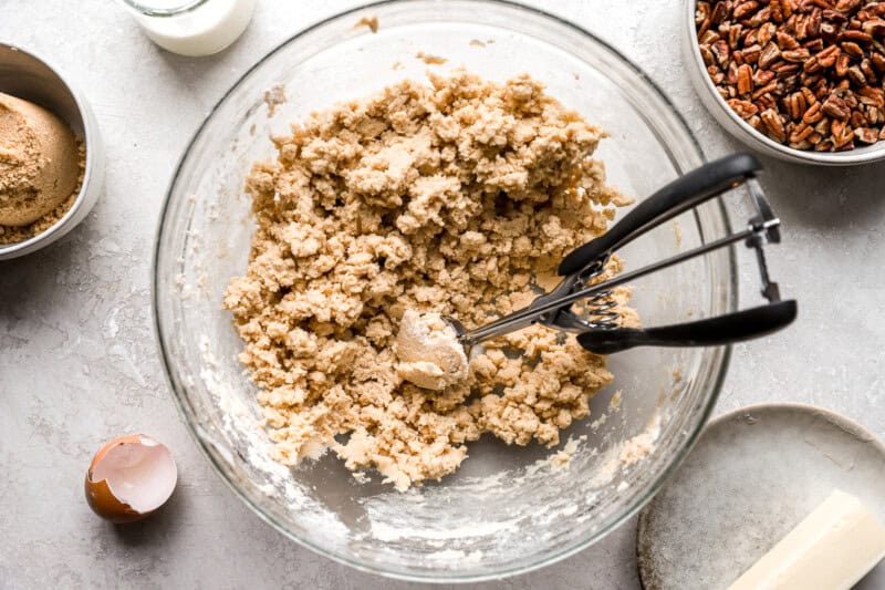 scooping cookie dough with a cookie scoop.