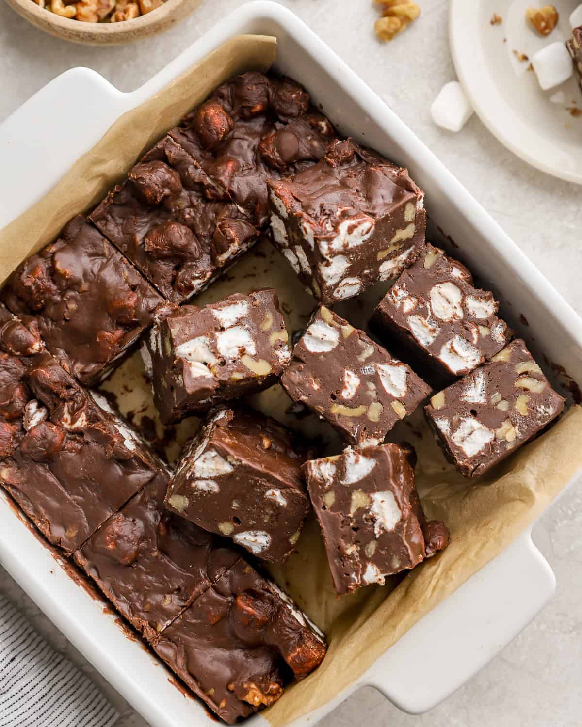 overhead view of partially cut rocky road fudge squares in a baking pan.