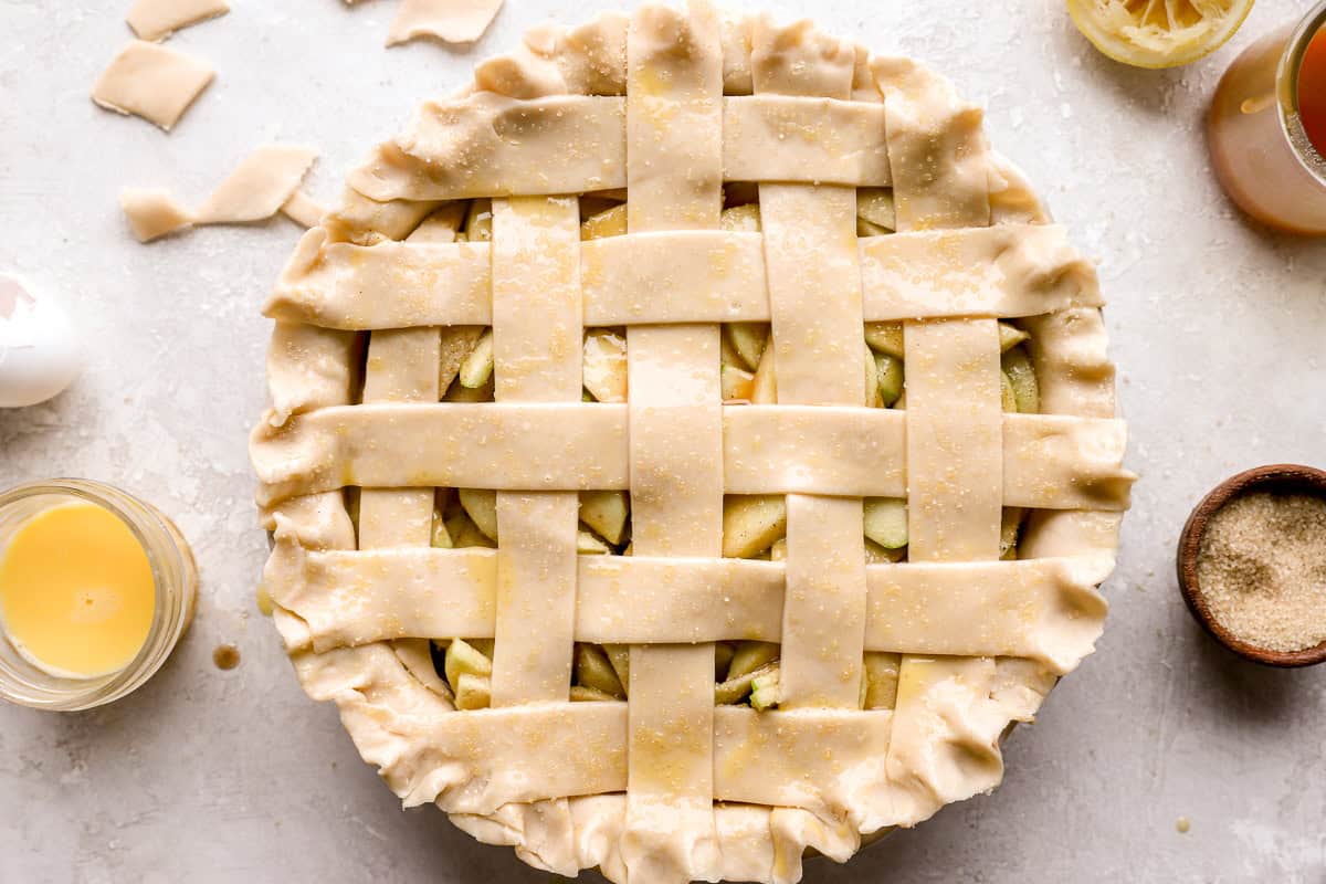 a latticed top placed on salted caramel apple pie.