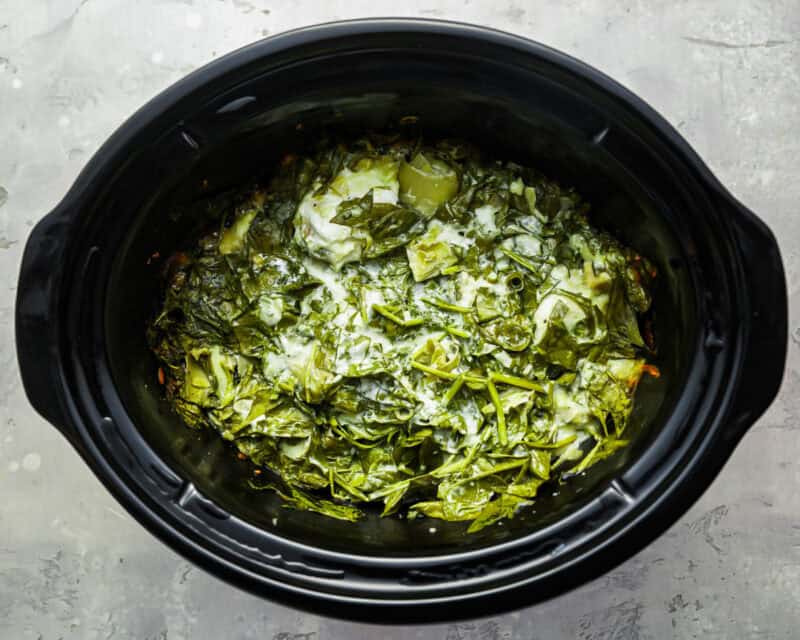 cooked spinach artichoke dip in a crockpot.