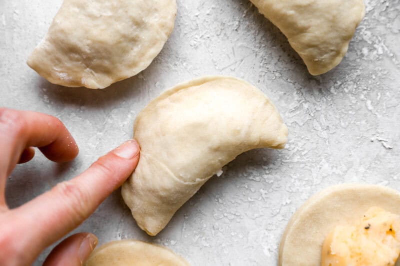 pressing a pierogi closed.