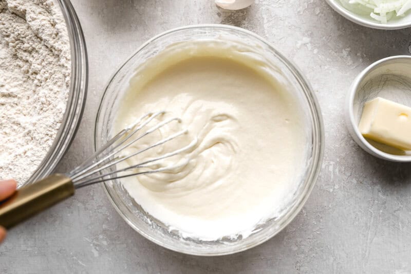 thick white batter in a bowl with a whisk.