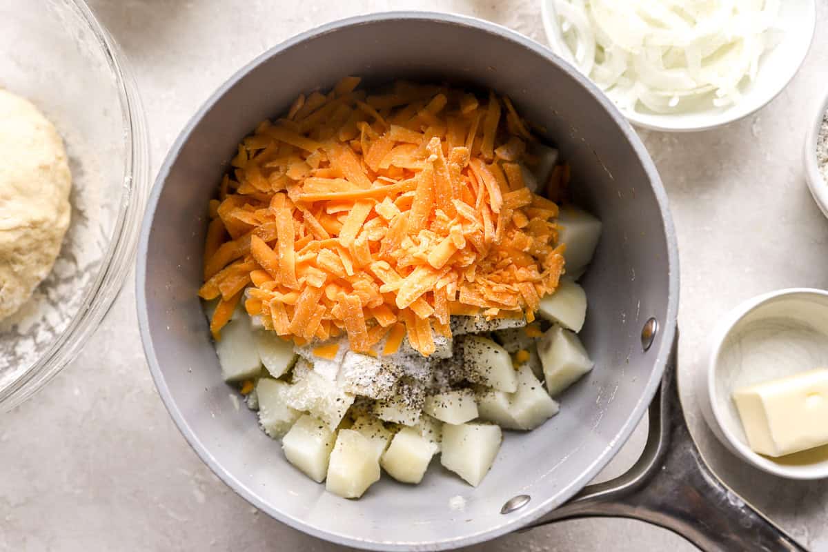 cheese and cubed cooked potatoes in a pot.