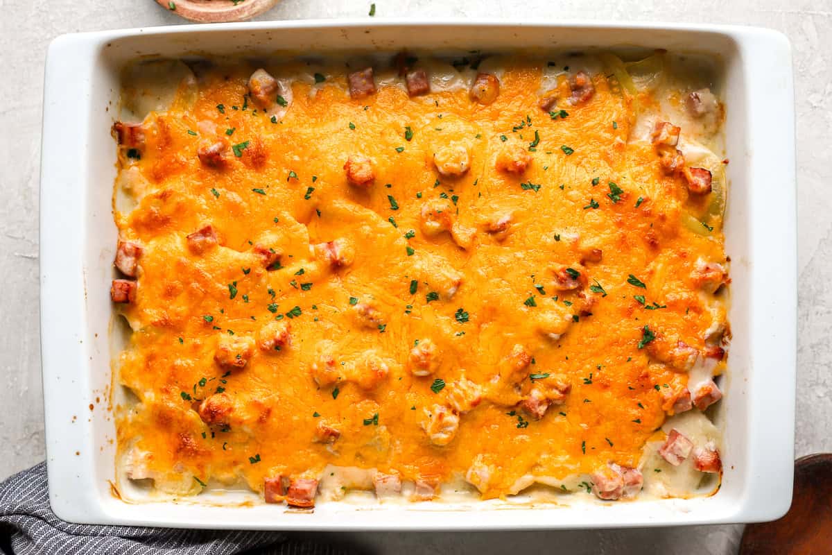 scalloped potatoes and ham in a casserole dish.